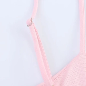 Detail of adjustable metal buckle and pink knitted strap on short striped dress
