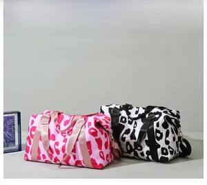 Detail view of pink and black leopard print travel bags with durable nylon webbing handles