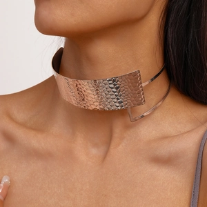 Macro shot of rose gold double-layered pleated collar necklace with hammered texture