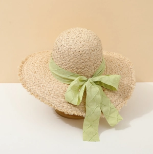Women's woven straw sun hat with light green chiffon bow for summer beach vacation
