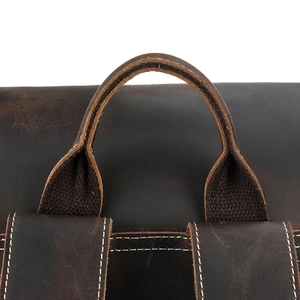 Macro detail of dark brown crazy horse leather handle and stitching on backpack