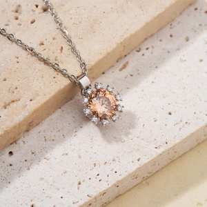 Elegant silver sunflower necklace featuring a champagne crystal and sparkling cubic zirconia