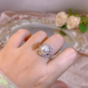 Macro detail of the elegant large white pearl ring with silver plating and zircon stones