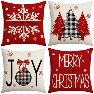 Set of four red and white Christmas throw pillow covers with festive lettering patterns