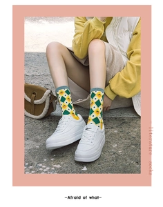 Detail of plaid strawberry mid-calf socks with vintage pattern and magazine-style layout