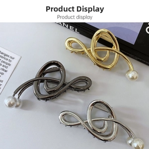 Detail of metallic hair claws in gold, silver and gunmetal with elegant pearls
