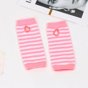 Detail of pink and white striped knit arm warmers with thumb holes on white background