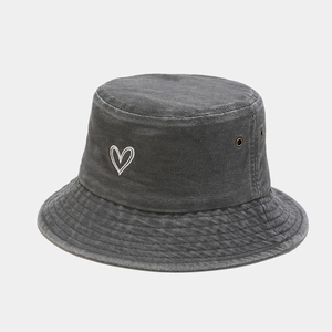 Detail view of heart embroidery and washed texture on a charcoal gray cotton bucket hat
