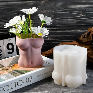 Detalle macro del molde de silicona de torso femenino y jarrón de resina rosa mate
