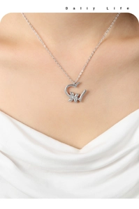 Macro view of a silver heart-shaped hollow pendant necklace on a female model