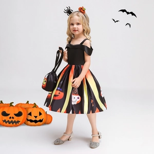 Detail of girls Halloween pumpkin costume with striped skirt, headband and matching bag