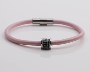 Detail of pink leather bracelet with silver magnetic clasp and black zircon slide bead