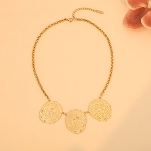 Detail of gold necklace with hammer textured irregular round pendants and lobster clasp
