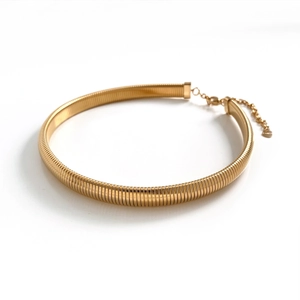 Close-up of golden metal choker with adjustable lobster clasp and extension chain detail
