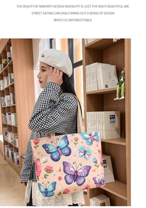 Detail view of ethnic canvas tote bag with vibrant blue butterfly and floral prints