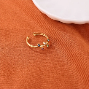 Vintage gold stainless steel flower open ring with colorful gemstones on orange fabric