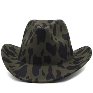 Detail of western cowboy felt hat with olive green base and black cow spots pattern