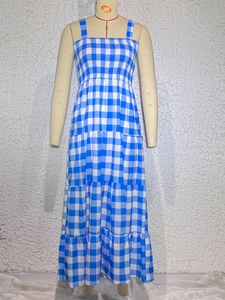 Detail of smocked elastic top and tiered gingham dress on a mannequin display