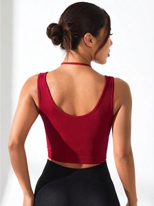 Detail of the deep red ribbed knit sports bra with U-back design and thin neck strap