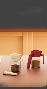 Detail of detachable kitchen seasoning jar with integrated spoon and easy-to-clean glass base