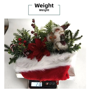 Detailed view of Santa Christmas wreath showing 218g weight on a digital scale
