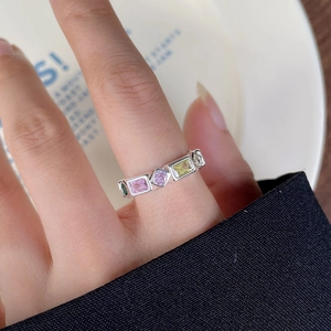 Detail of S925 silver ring featuring multicolored rectangular and round gemstones on hand