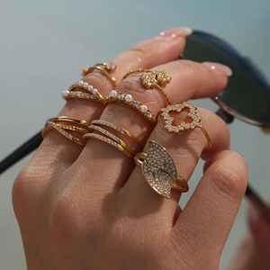 Set of geometric 18k gold plated stainless steel rings with zircon and pearls on hand