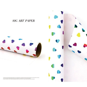 Macro detail of 80g art paper roll with colorful gradient heart patterns for gift wrapping