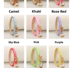 Detail shot of slim leather belts featuring elegant gold butterfly buckles in vibrant colors