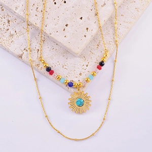 Detail of bohemian double-layer necklace with colorful beads and golden sun pendant
