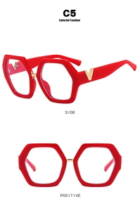 Detail of red hexagonal frames with signature gold V-shaped metal hinge accents