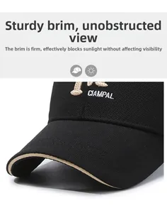 Detail of black baseball cap with white CIAMPAL embroidery and beige piping edge