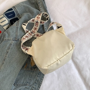 Cream large capacity waterproof nylon crossbody bag with printed wide shoulder strap