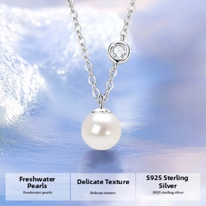 Macro detail of white freshwater pearl pendant with sparkling zircon on S925 silver chain