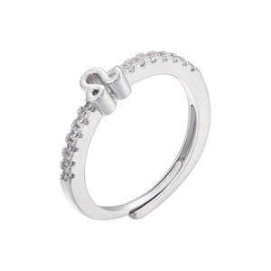 Macro detail of silver Leo zodiac ring featuring pavé cubic zirconia and open band