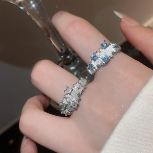 Irregular geometric silver ring with blue rectangular gemstones and zircon textures