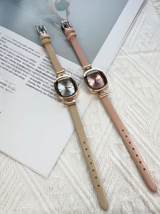 Close-up of minimalist oval quartz watches with beige and pink leather straps and BARSH dials