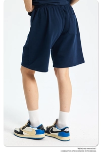 Rear view of vintage blue acid wash cotton shorts showing loose fit and pocket detail