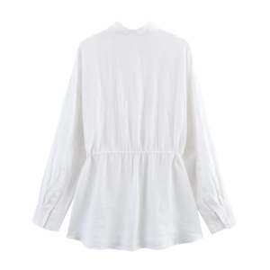 Detail of white long-sleeved shirt featuring gathered waist and natural cotton-linen texture