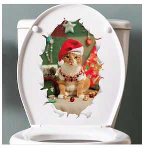 Close-up of a Christmas cat decal with 3D torn paper effect on a white toilet lid