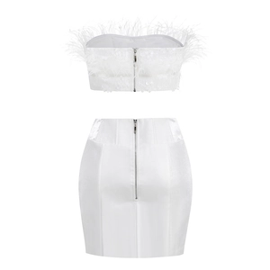 Back view of white two-piece set featuring ostrich feathers, sequins and zipper closures