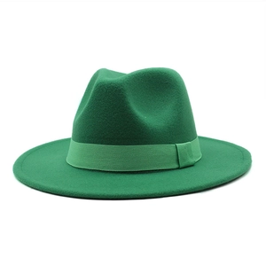 Detailed close-up of dark green wool felt fedora hat with matching grosgrain ribbon