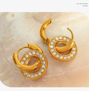 Macro detail of gold double-hoop earrings featuring pavé set white zircon stones