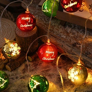 Detail of LED Christmas globe lights with Merry Christmas print on rustic wood