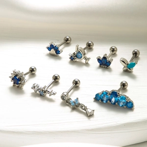 Set of 8 silver stud earrings featuring blue zircon flowers, crowns, and butterflies
