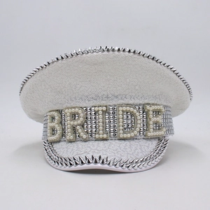 Close-up of white sequin captain hat with pearl Bride lettering and silver metal spikes