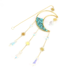 Macro detail of moon suncatcher with celestial crystals and hanging blue stones