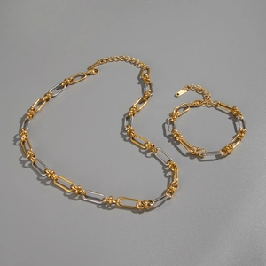 Detailed macro view of two-tone gold and silver S925 oval link chain jewelry set
