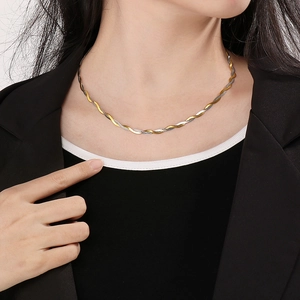 Close-up of a two-tone twisted rope chain necklace in gold and silver on a model