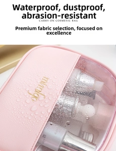 Detail of pink waterproof cosmetic bag with water droplets and gold brand logo